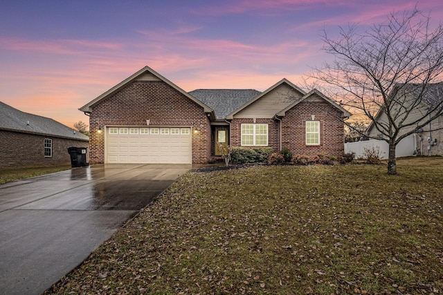 view of front of house with a garage and a lawn