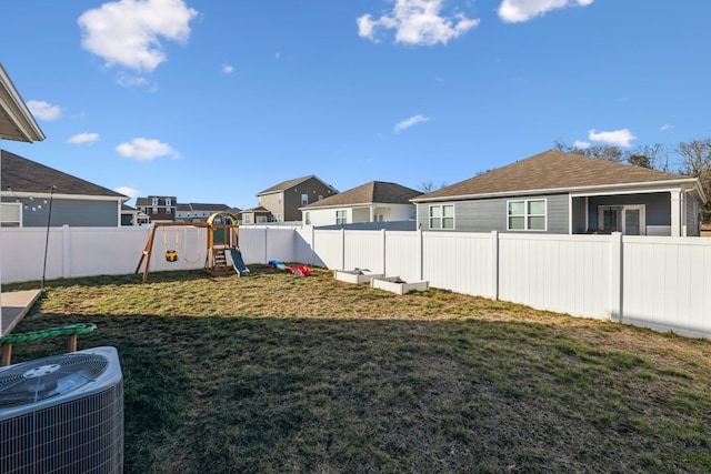 view of yard with central AC unit and a playground