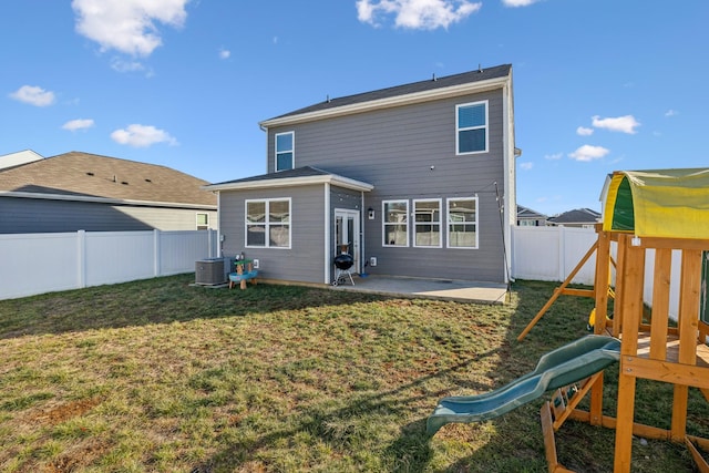 rear view of property with central AC, a yard, a playground, and a patio