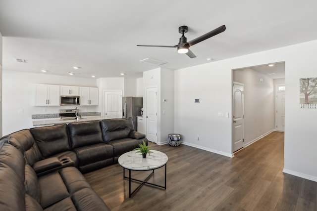 living room with dark hardwood / wood-style floors and ceiling fan