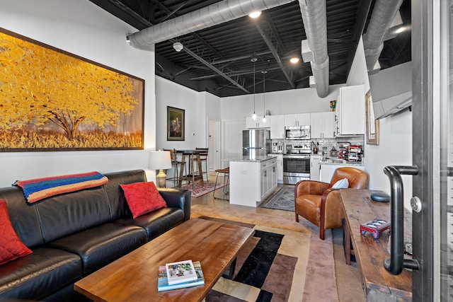 living room featuring a towering ceiling