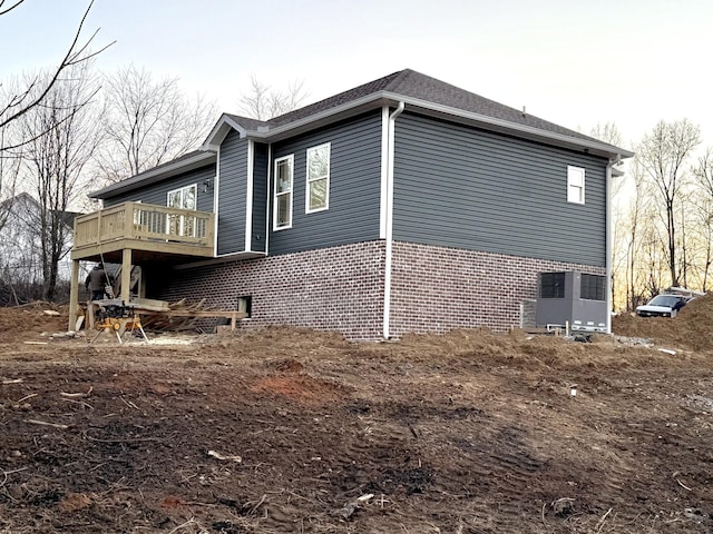 view of side of home featuring a wooden deck