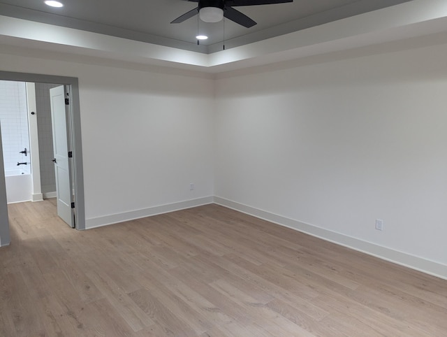 empty room with light hardwood / wood-style flooring and ceiling fan