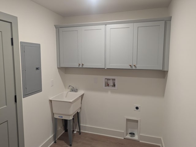 laundry room with dark hardwood / wood-style flooring, cabinets, washer hookup, electric panel, and hookup for an electric dryer