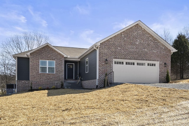 ranch-style house with a garage, driveway, brick siding, and entry steps