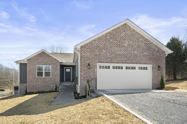 ranch-style home featuring a garage, driveway, and brick siding