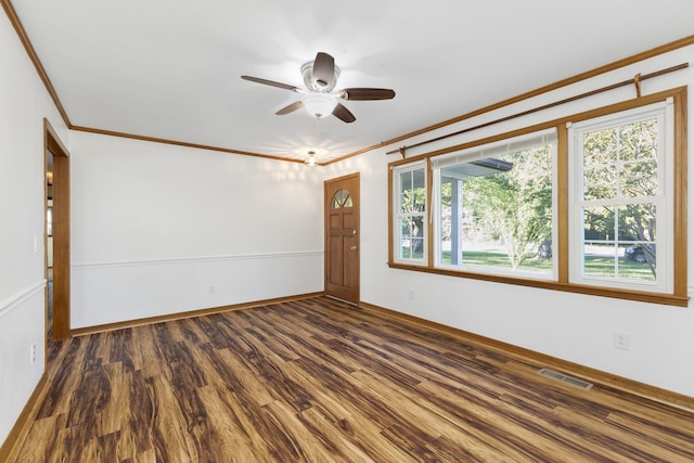 spare room featuring ceiling fan, crown molding, dark hardwood / wood-style floors, and a healthy amount of sunlight