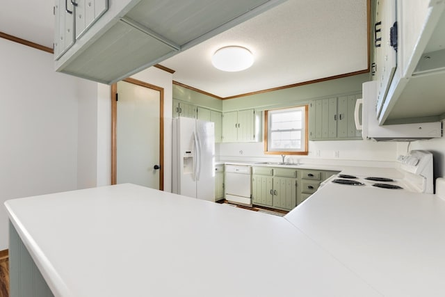 kitchen with ornamental molding, sink, white appliances, and kitchen peninsula