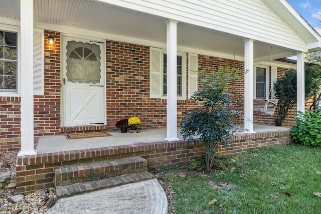 view of exterior entry with a porch