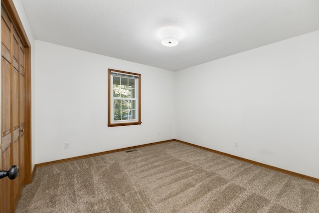 unfurnished room with carpet floors