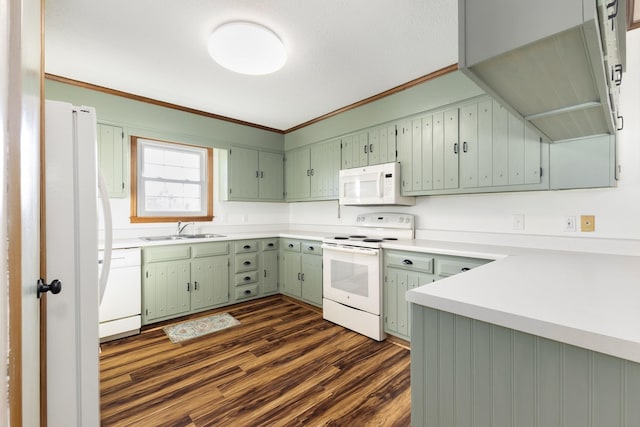 kitchen featuring crown molding, sink, white appliances, and dark wood-type flooring