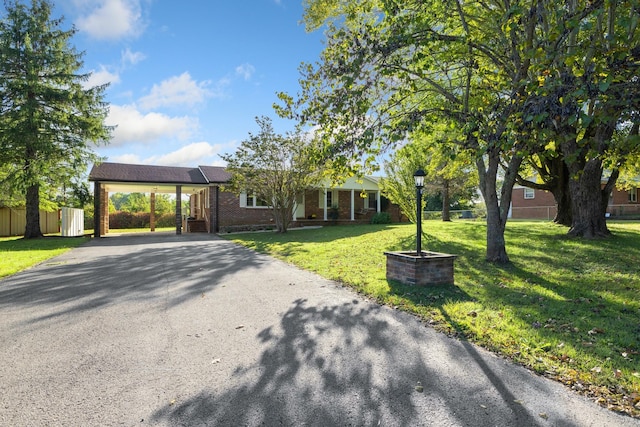 view of front of property with a front yard and a carport