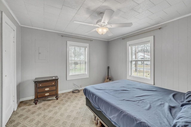 bedroom with ceiling fan, ornamental molding, electric panel, and light carpet