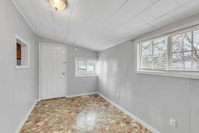 unfurnished room featuring lofted ceiling