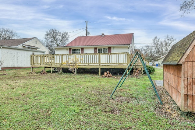 rear view of property with a yard and a deck