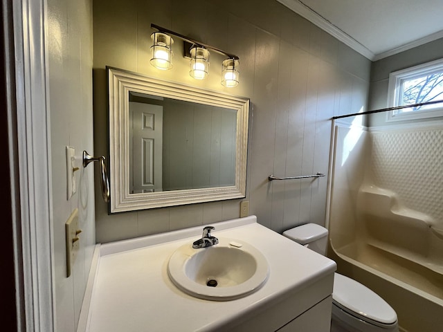 full bathroom featuring ornamental molding, shower / washtub combination, vanity, and toilet