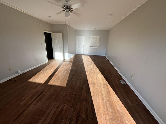 unfurnished room with crown molding, dark wood-type flooring, and ceiling fan