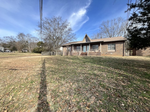 single story home featuring covered porch and a front lawn