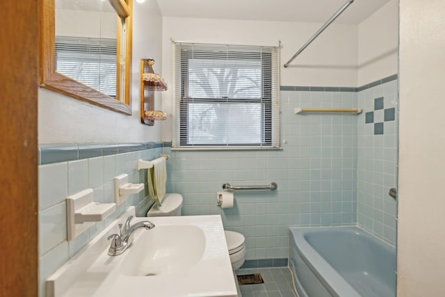 full bathroom with tile walls, sink, tile patterned flooring, and toilet