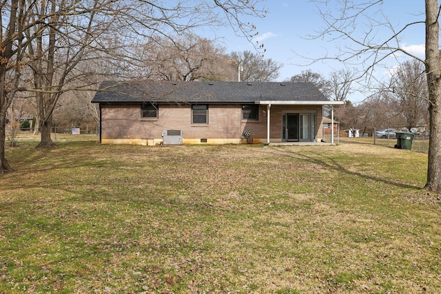 back of property with a yard and central air condition unit