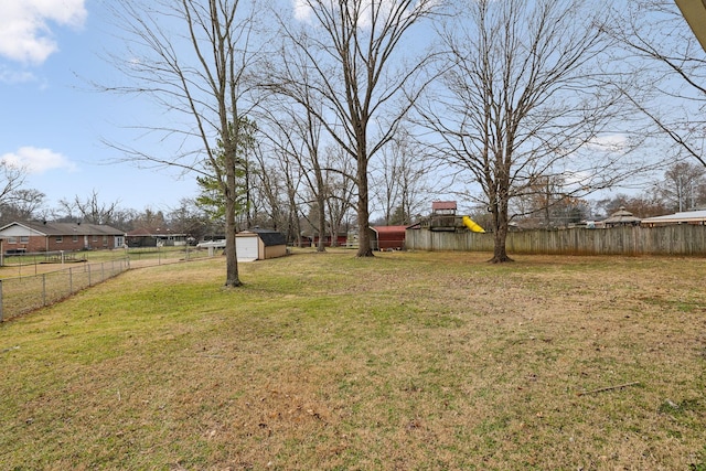 view of yard with a playground and a shed