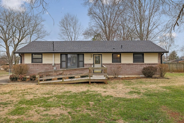 ranch-style home featuring a wooden deck and a front yard