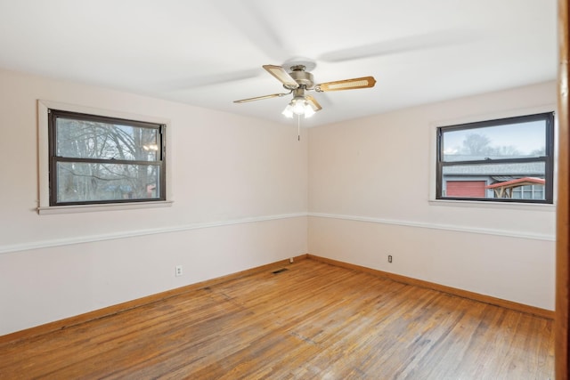 spare room with hardwood / wood-style flooring and ceiling fan