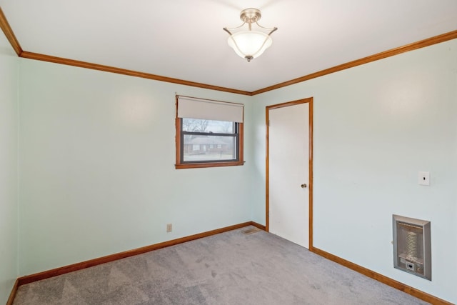 spare room featuring ornamental molding, light carpet, and heating unit