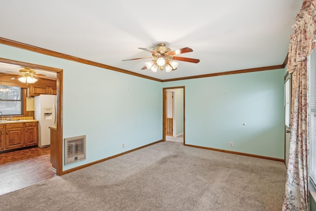 carpeted spare room featuring ornamental molding and ceiling fan