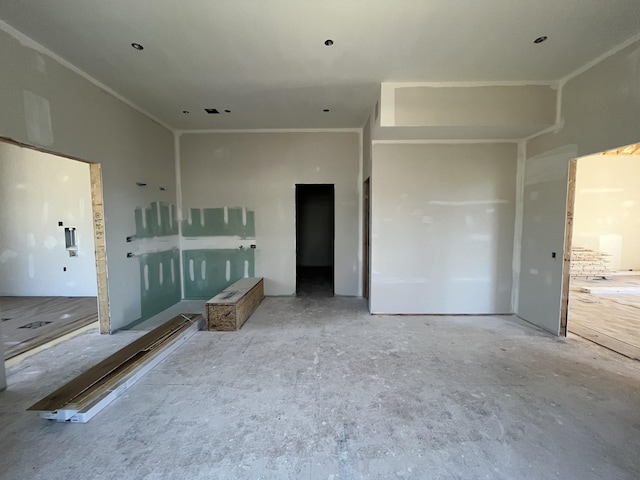 unfurnished living room featuring crown molding