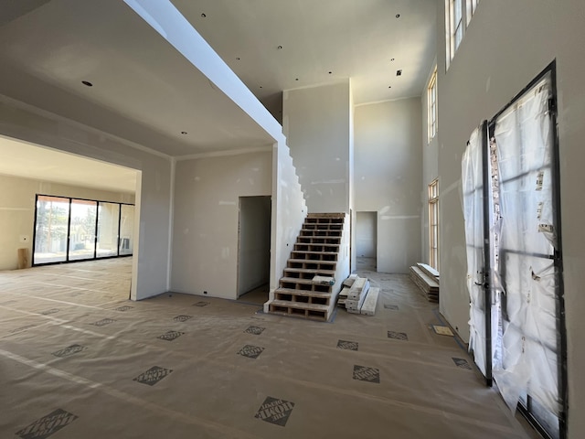 interior space with a high ceiling and stairs