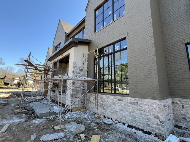 view of side of property with brick siding