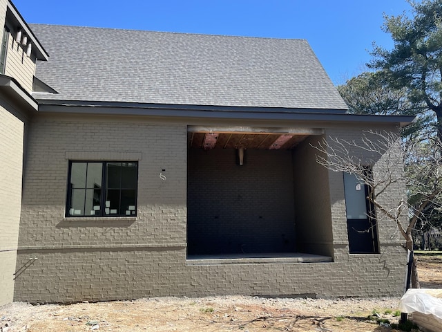 view of side of property featuring brick siding