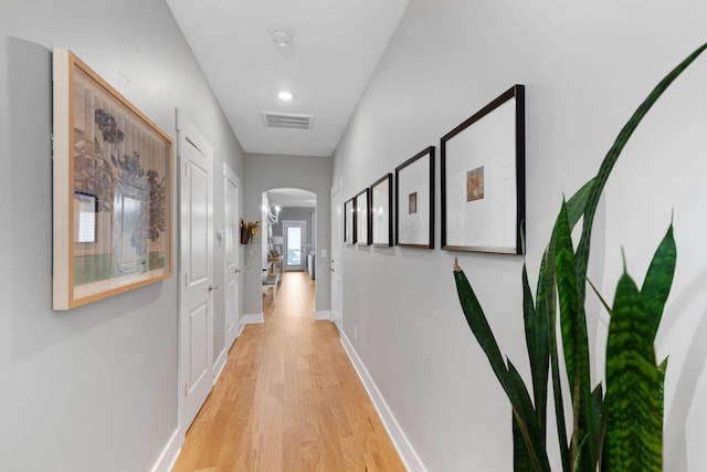 corridor with light hardwood / wood-style floors