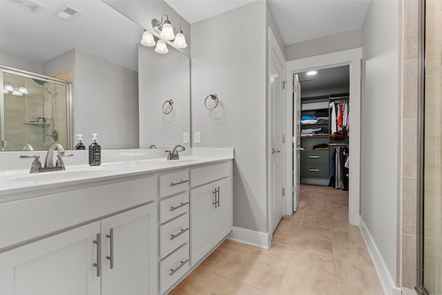 bathroom with walk in shower, tile patterned floors, and vanity