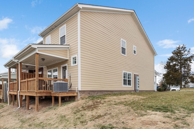 view of property exterior featuring a wooden deck, cooling unit, and a lawn