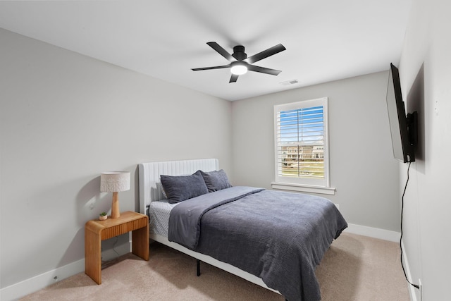 bedroom with light colored carpet and ceiling fan