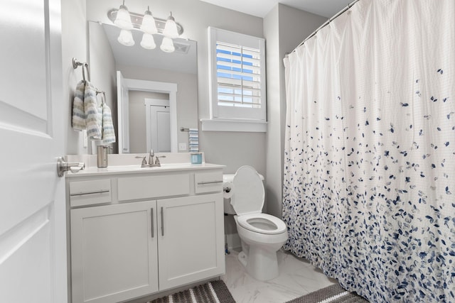 bathroom featuring vanity, curtained shower, and toilet