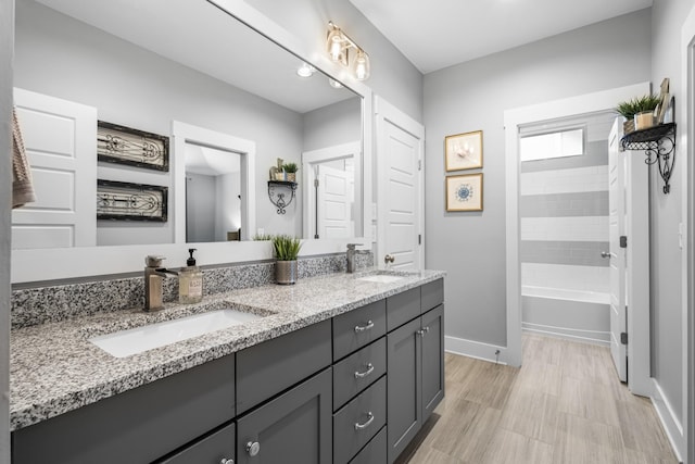 bathroom featuring shower / bathtub combination and vanity