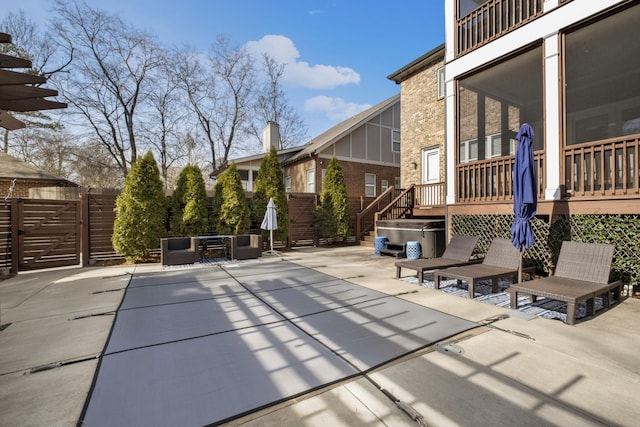 exterior space featuring a wooden deck and a hot tub