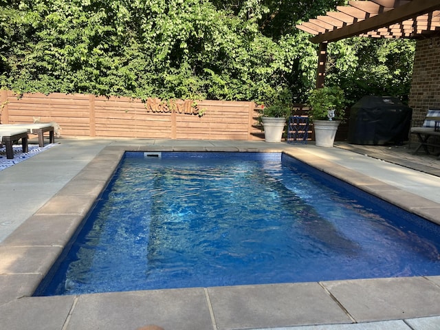 view of pool featuring a grill, a pergola, and a patio