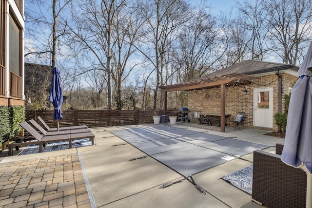 view of patio with grilling area and a pergola