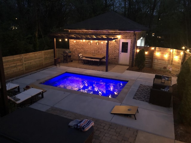 pool at twilight featuring a pergola and a patio