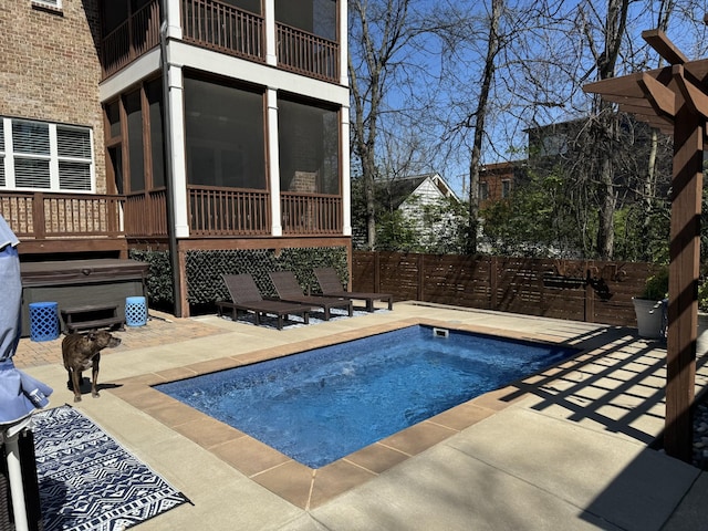 view of pool with a patio area, a hot tub, and a sunroom