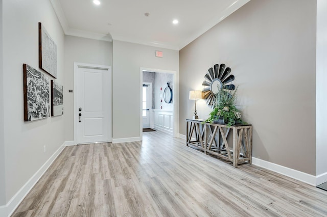 entryway with light hardwood / wood-style flooring and ornamental molding