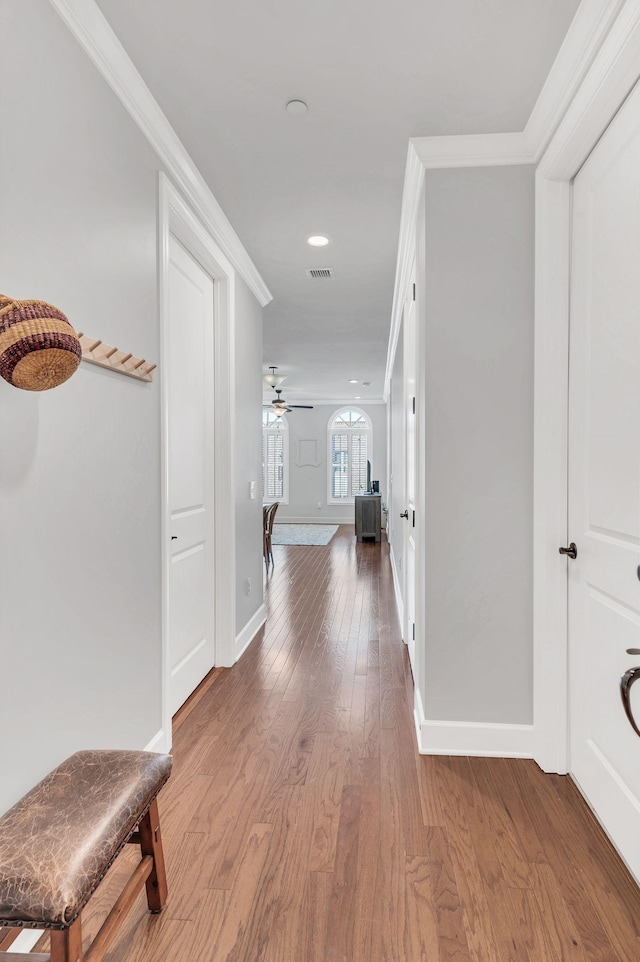 hall featuring hardwood / wood-style flooring and ornamental molding