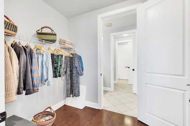 walk in closet with wood-type flooring