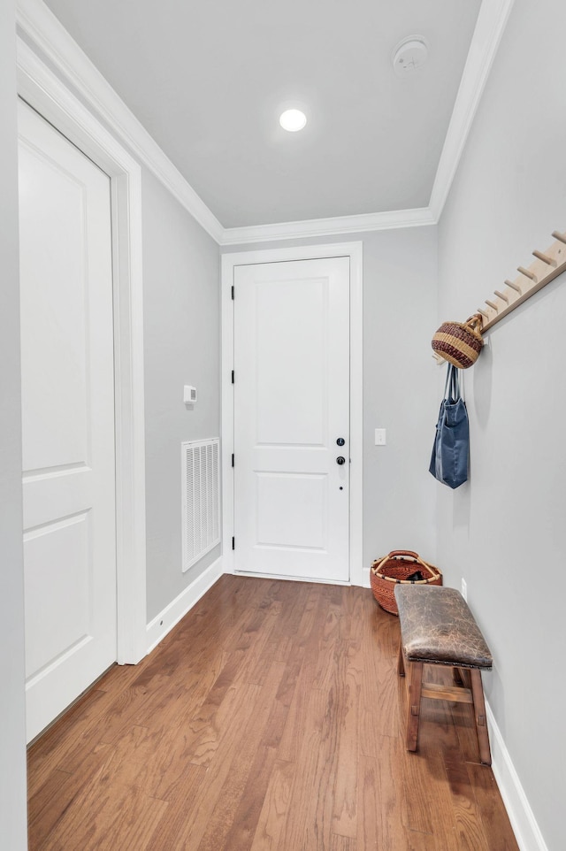 entryway featuring crown molding and light hardwood / wood-style flooring