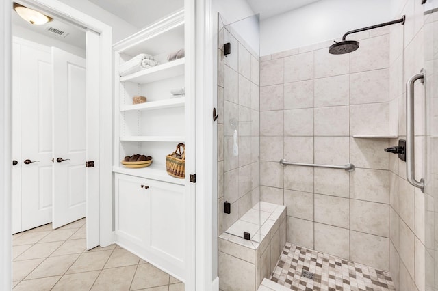 bathroom featuring a tile shower and tile patterned floors