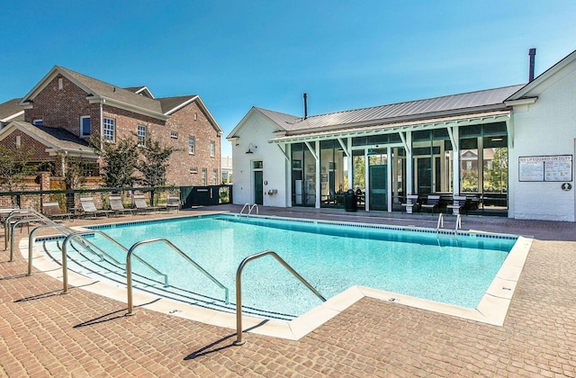 view of swimming pool featuring a patio area